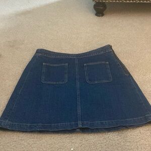 Loft a line denim skirt with patch pockets in front and slash pockets in back.